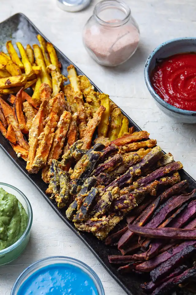 a plate of rain french fries with dips