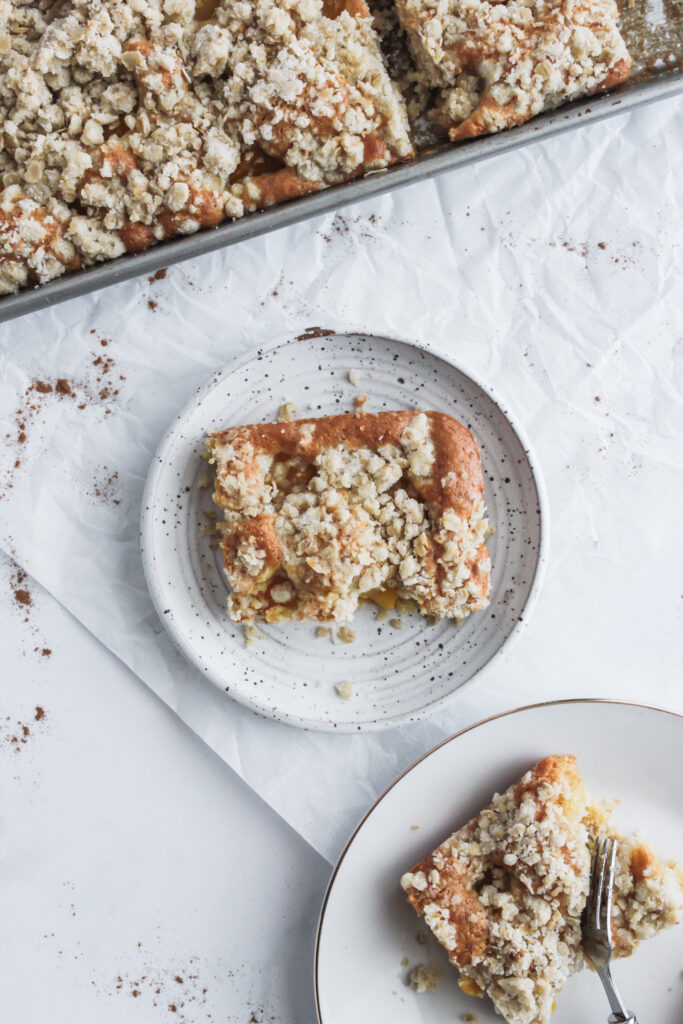 A piece of peach streusel coffee cake on a plate 