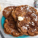 vegan pumpkin spice waffles with a glass of orange juice