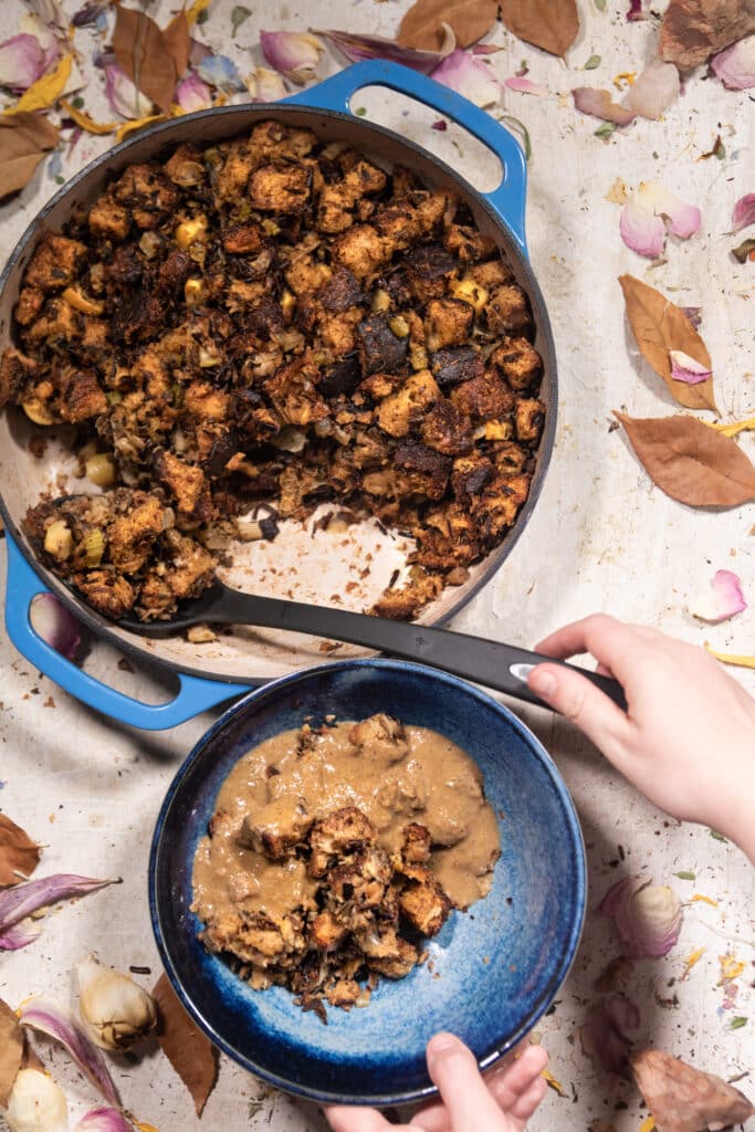 Minnesotan Wild Rice, Apple, Mushrooms Stuffing being served into a bowl with sage gravy