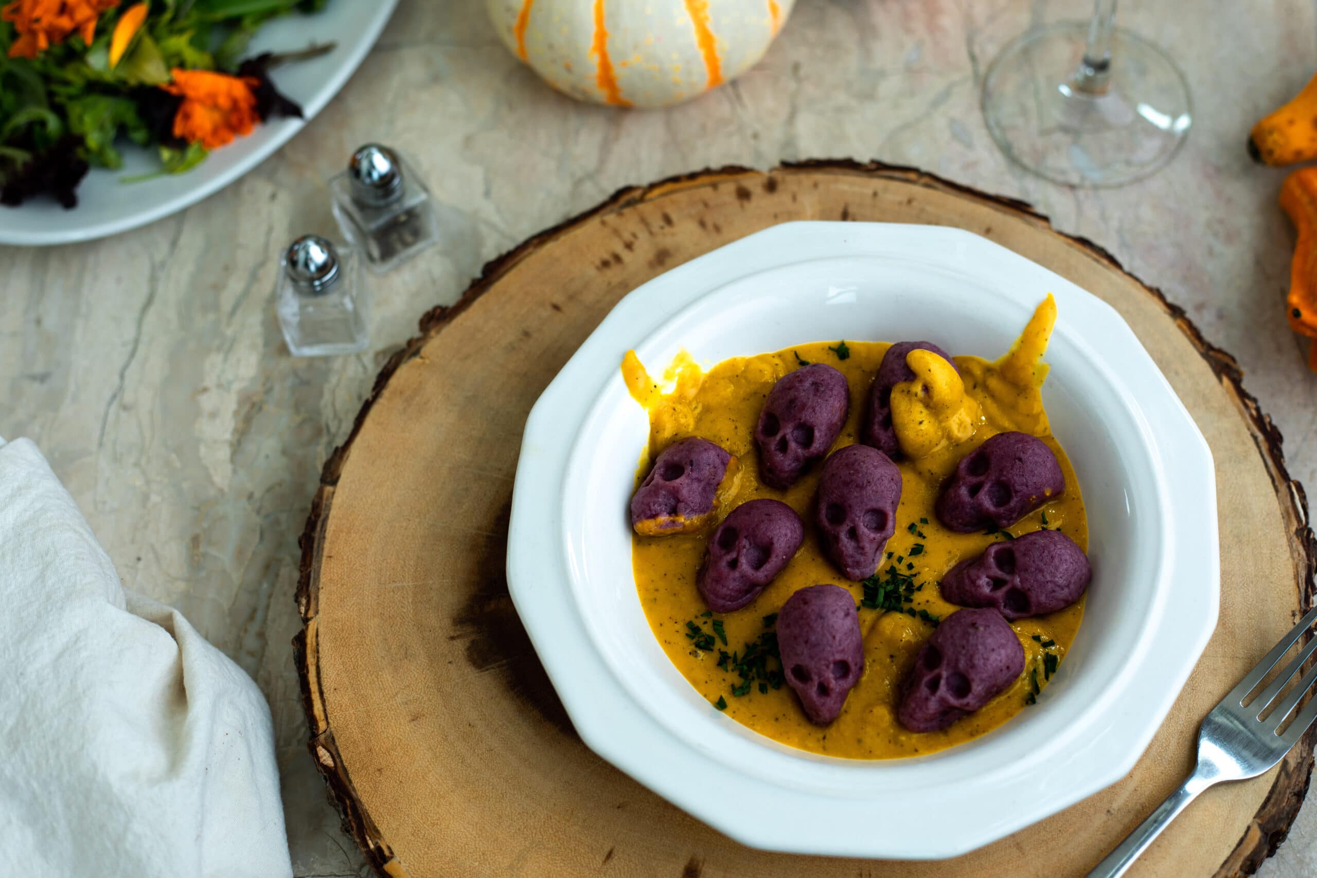 a plate of purple skull shaped gnocchi