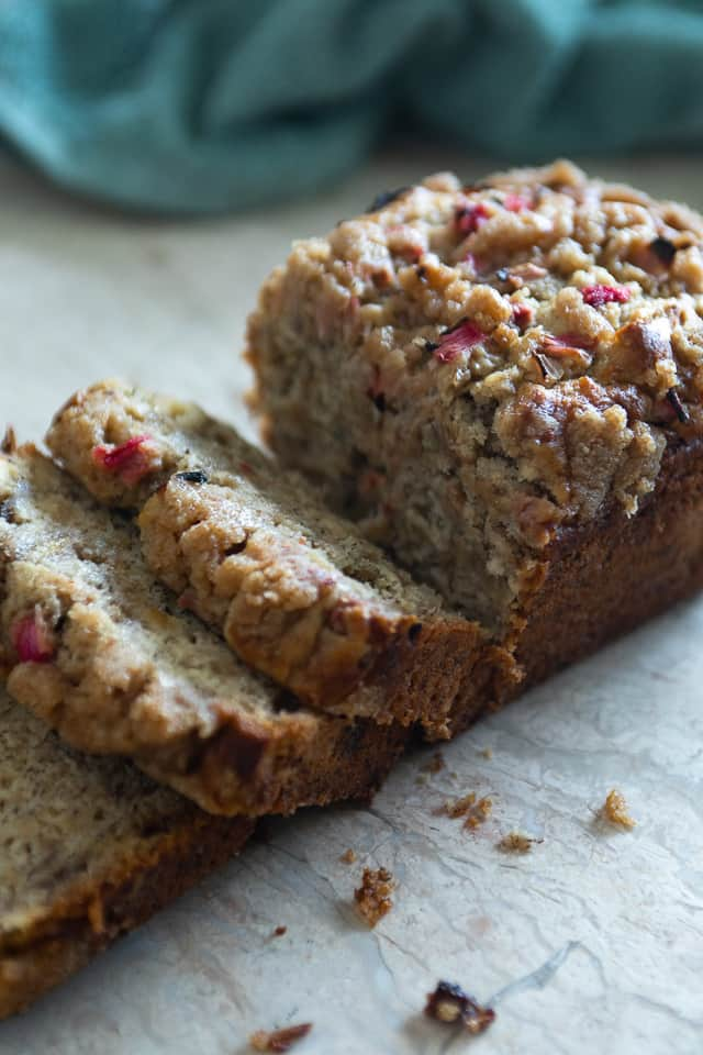 A loaf of banana bread that is being sliced