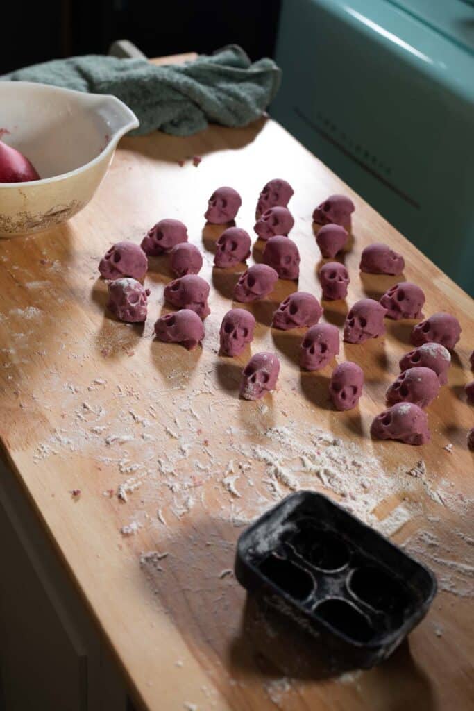 Rows of skull shaped gnocchi on a board