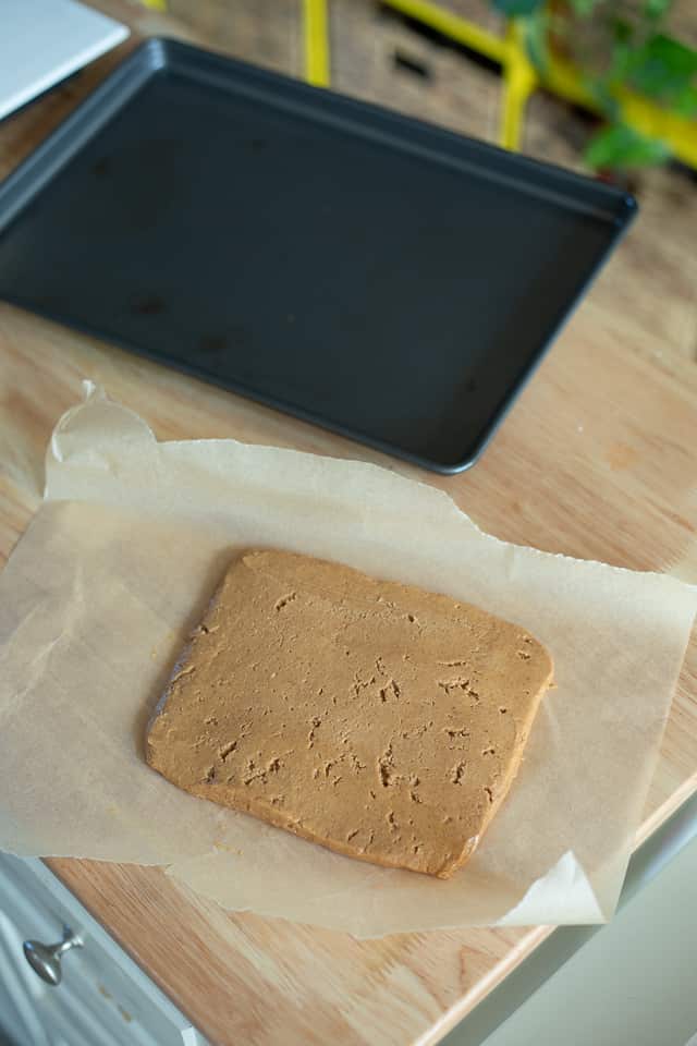 A square of peanut butter on parchment paper