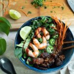 A bowl of pho with vegan shrimp and seitan steak