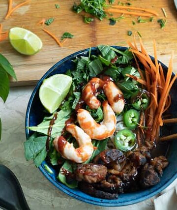 A bowl of pho with vegan shrimp and seitan steak