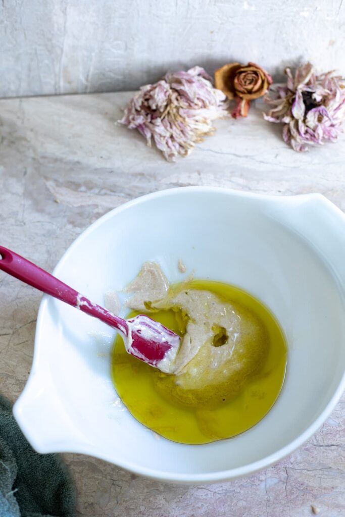 a bowl of sourdough started with infused garlic olive oil 