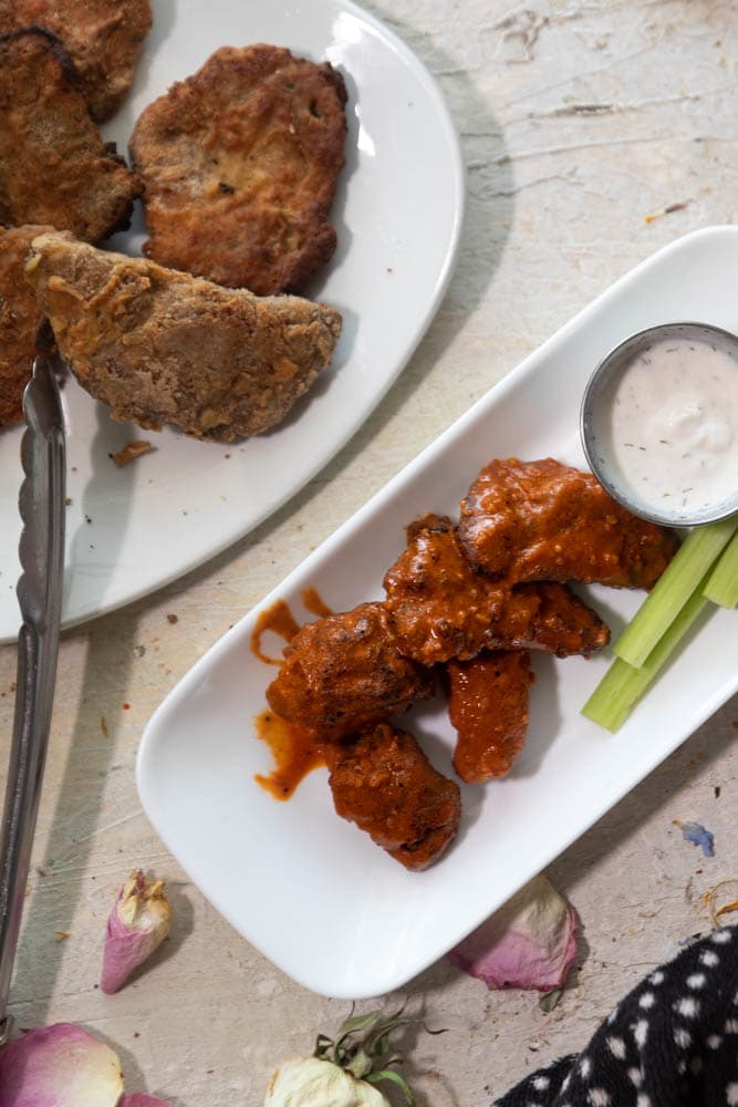 a plate of chicken of the woods wings