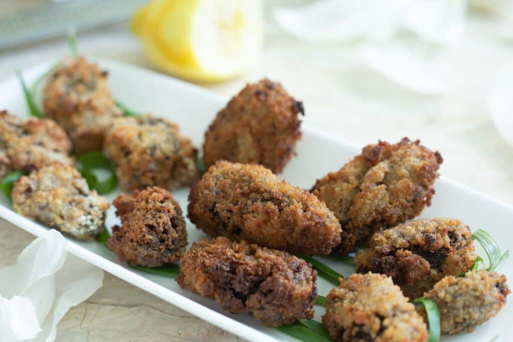 a plate of breaded and fried morel mushrooms