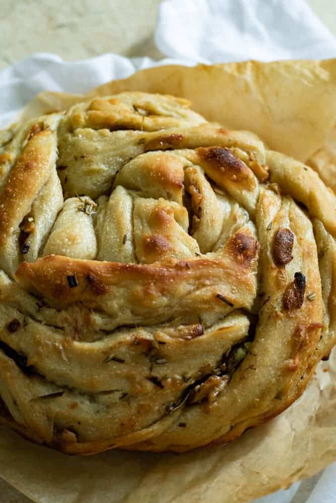 A loaf of pull apart bread on parchment paper