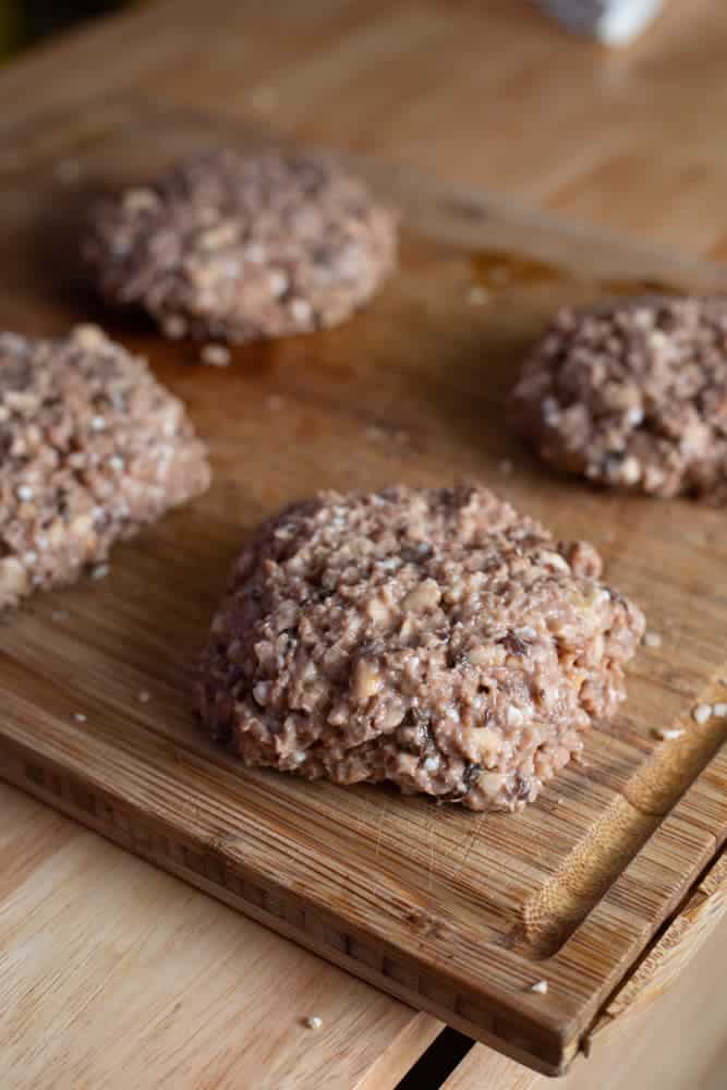 formed burger patties on a wooden cutting board