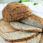 A sliced loaf of sourdough bread on a cutting board