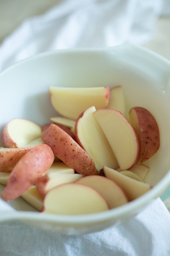 a bowl of cut raw potatoes