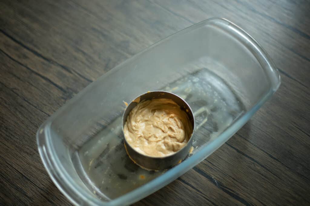 Cheese inside of a pastry ring in a glass container