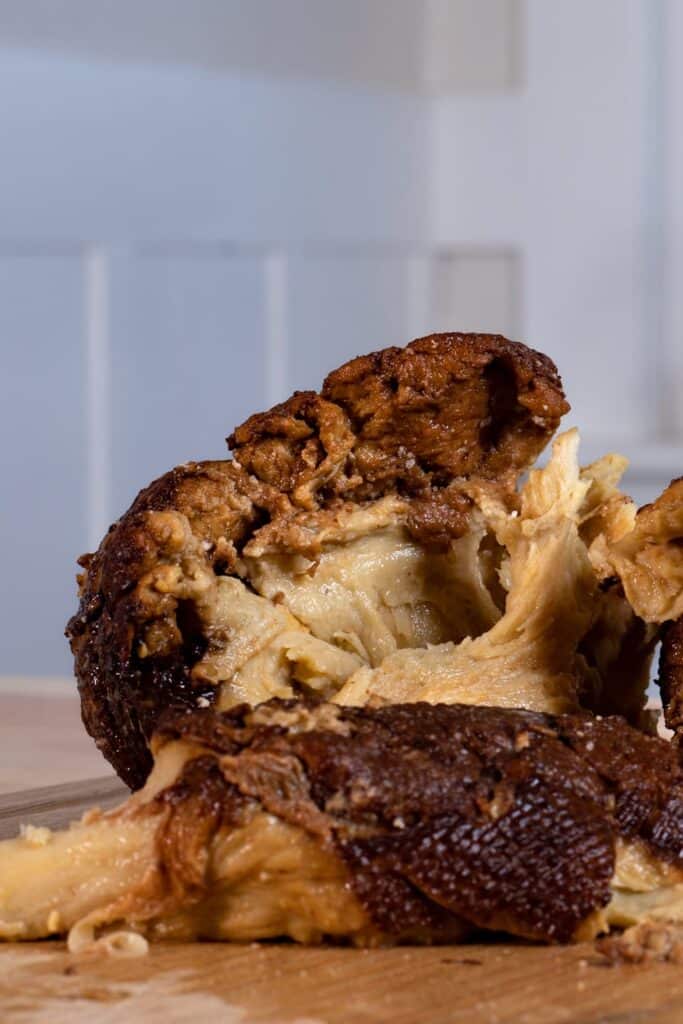 Shredded up seitan on a wooden cutting board