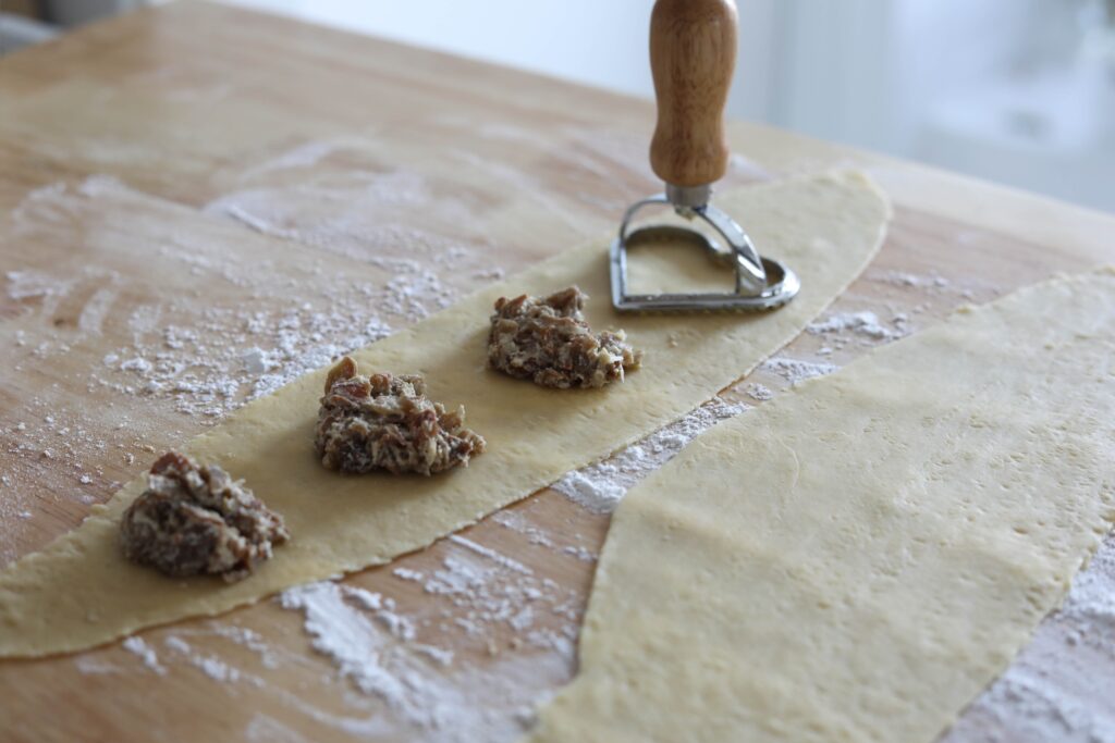 pasta rolled out with a ravioli cutter on top